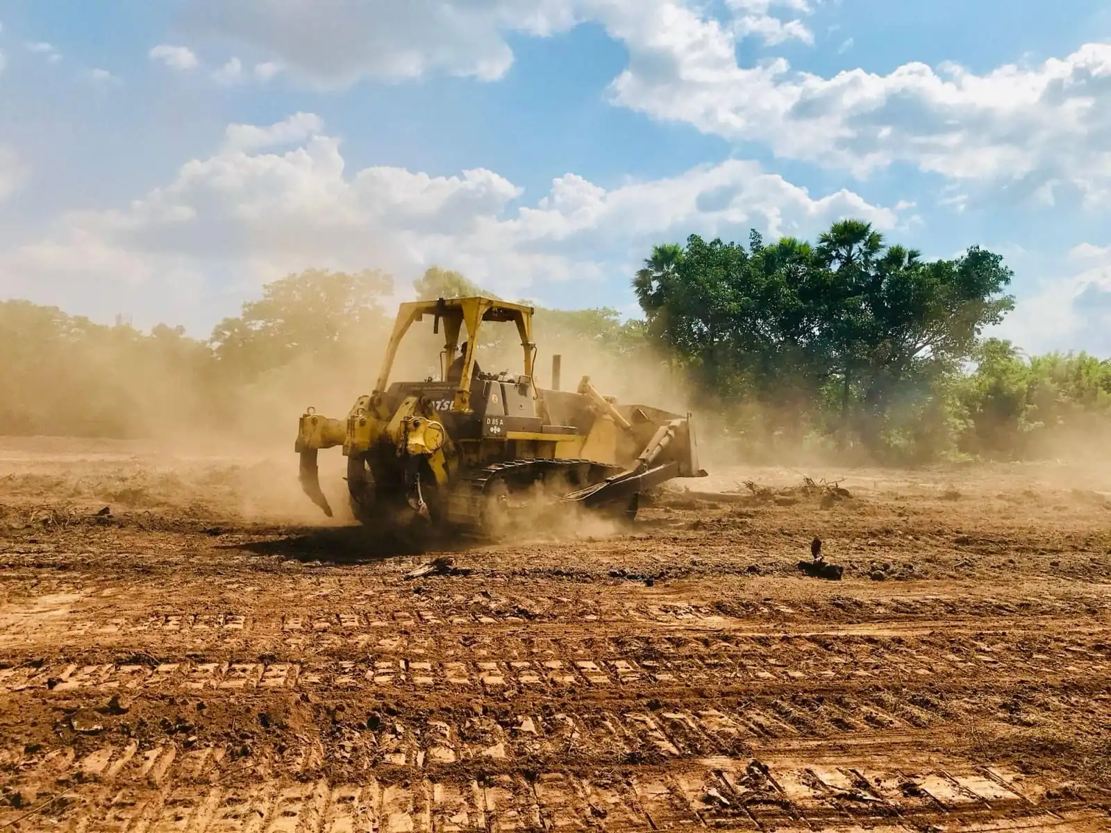Heavy machinery shaping ground on a construction site